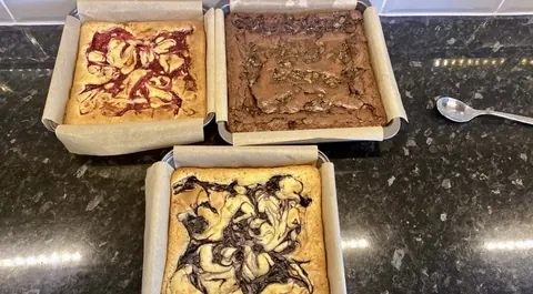 Four cakes are on a table, each with a different design.
