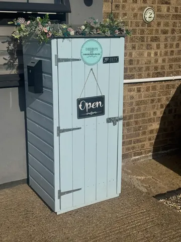 A blue and white container with a sign that says "open" on it.