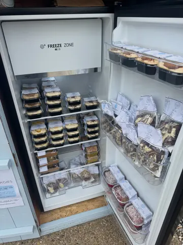 A refrigerator with a lot of food in it.