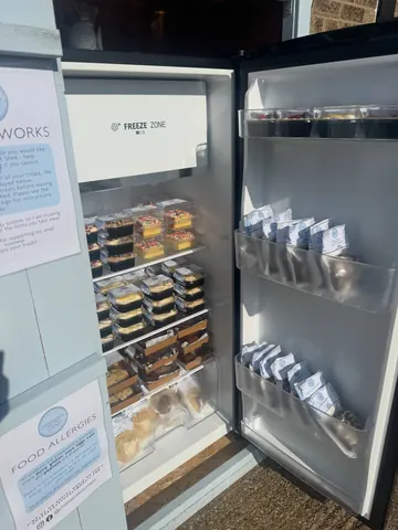 A refrigerator with a sign on the door.