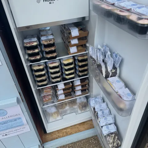 A refrigerator with a lot of food in it.