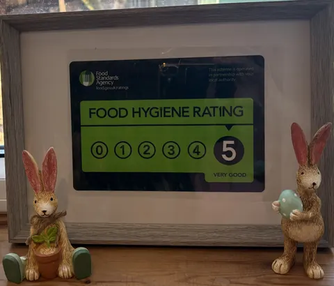 A picture of two bunnies with a sign that says "Food Hygiene Rating" in front of them.
