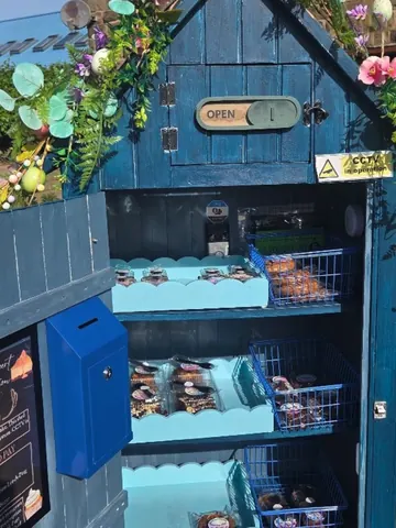 A blue box with a sign that says open.