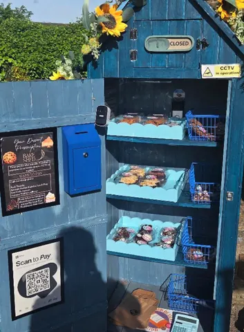 A blue box with a blue shelf inside of it.