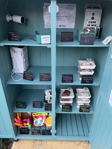 A blue shelf with a white box on it.