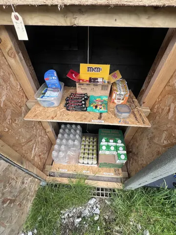 A wooden box with a variety of items inside.