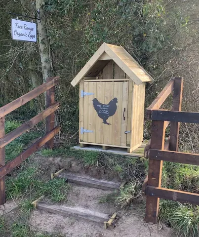 A wooden fence with a sign on it.