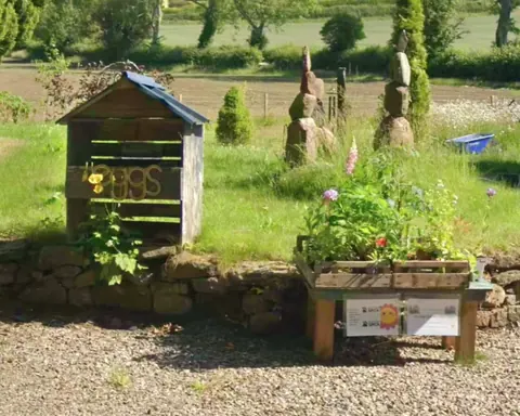 A wooden shed with a sign on it that says "Bogs".