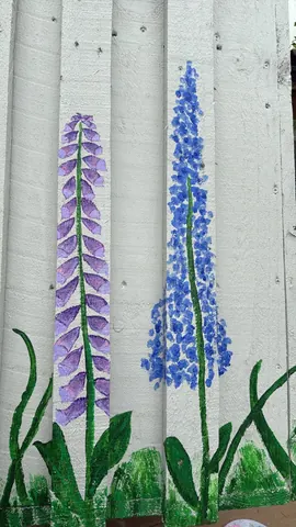 A wall with two blue flowers painted on it.