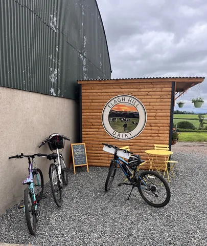 Two bicycles are parked in front of a building.