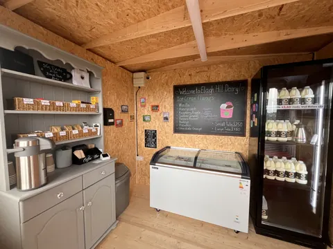 A refrigerator with a sign on it that says Welcome to Llagh Dairy.