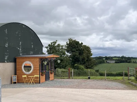 A small wooden building with a sign on the side.