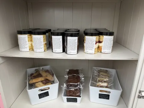 A shelf with a variety of food items on it.