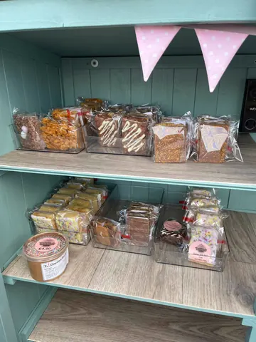 A shelf with a variety of food items on it.