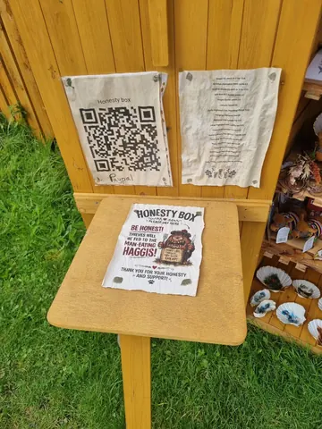 A table with a sign that says Honest Box.