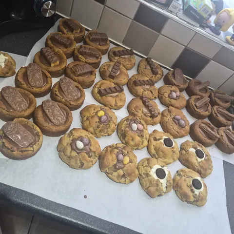 A tray of cookies with chocolate and marshmallows on top.