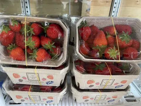 A stack of strawberries in a box.