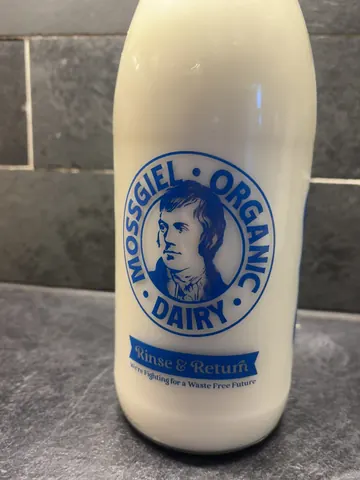 A bottle of milk with a blue label.