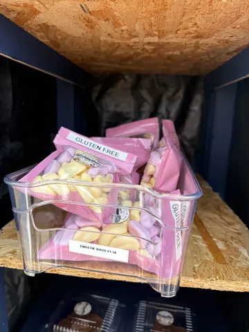 A box of marshmallows is sitting in a plastic container.