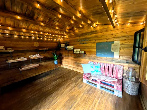 A wooden room with a bench and a sign on the wall.