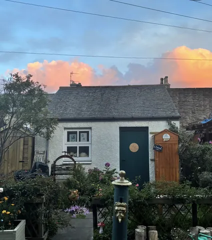 A house with a green door and a white roof.