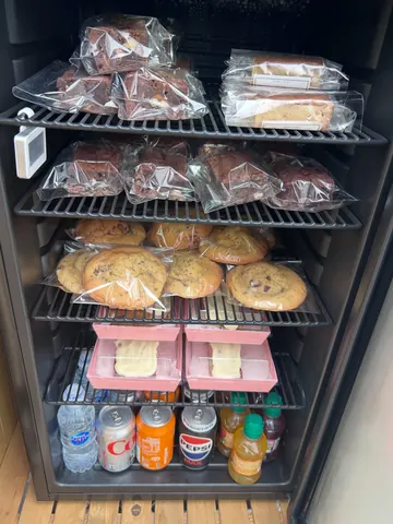 A refrigerator with a variety of food items and drinks inside.