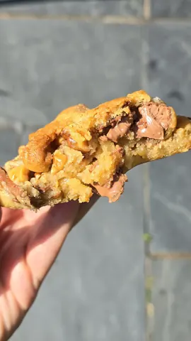 A hand holding a half eaten pastry.