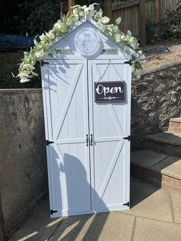 A white door with a sign on it that says "Open".
