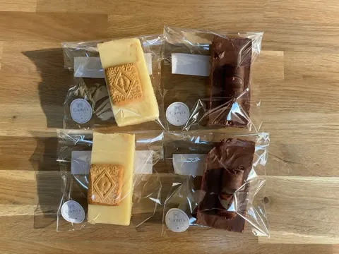 Four packages of food are sitting on a table.