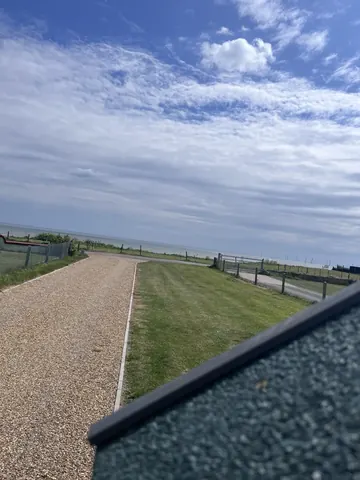 A view of a road with a fence on the side.