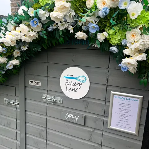 A sign that says "Bakery Lane" is on a door.