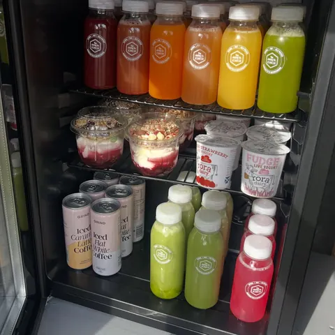 A refrigerator with a variety of drinks and food items inside.
