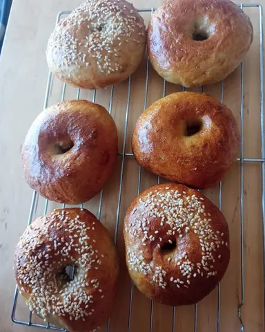 A tray of bread with sesame seeds on it.