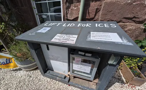 A box with the words "lift lid for ice" written on it.
