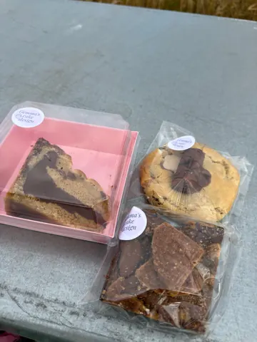 A box of cookies and a box of cake are on a table.