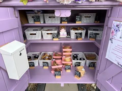 A purple cabinet with a white box on the bottom.