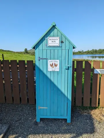 A blue shed with a sign on it.