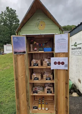 A wooden shed with a sign on the door.