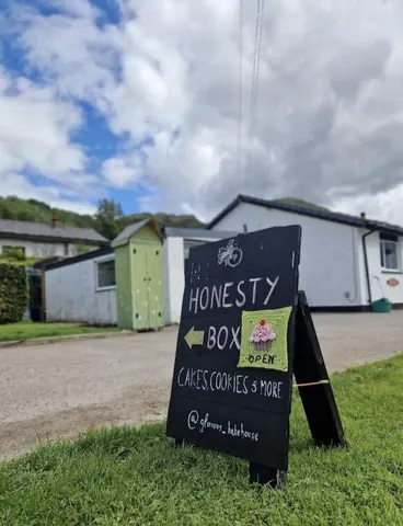 A sign is posted in front of a house.