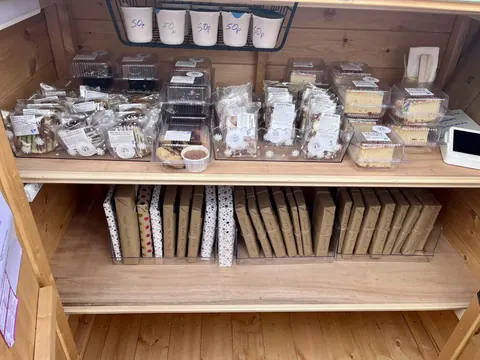 A wooden shelf with a variety of items on it.