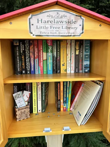 A wooden box with a sign that says Harleys Free Library of Popular Literature.