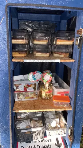 A blue cabinet with a sign that says Millionaire Shortbread 20p.