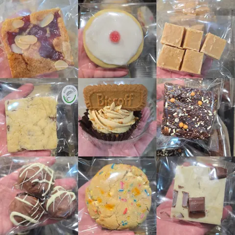A person holding a variety of desserts in their hand.