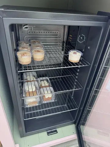A refrigerator with a shelf full of food.