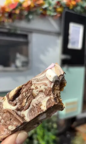 A person is holding a piece of cake.