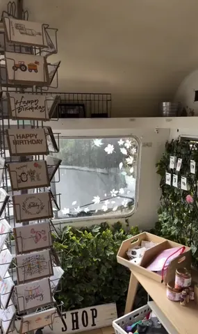 A card display with cards and a box of cards.