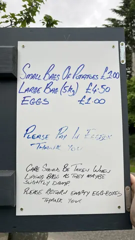A sign that says Small Bags of Potatoes for sale.