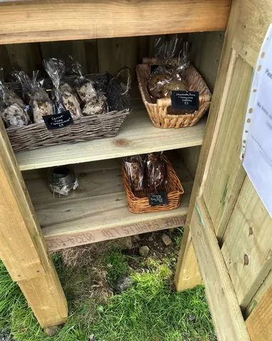 A wooden box with a sign that says "Cakes" on it.