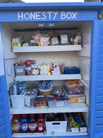 A blue box with a white shelf inside of it.