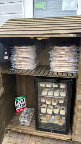 A pizza box with a sign that says "The Best Pizza in Town".